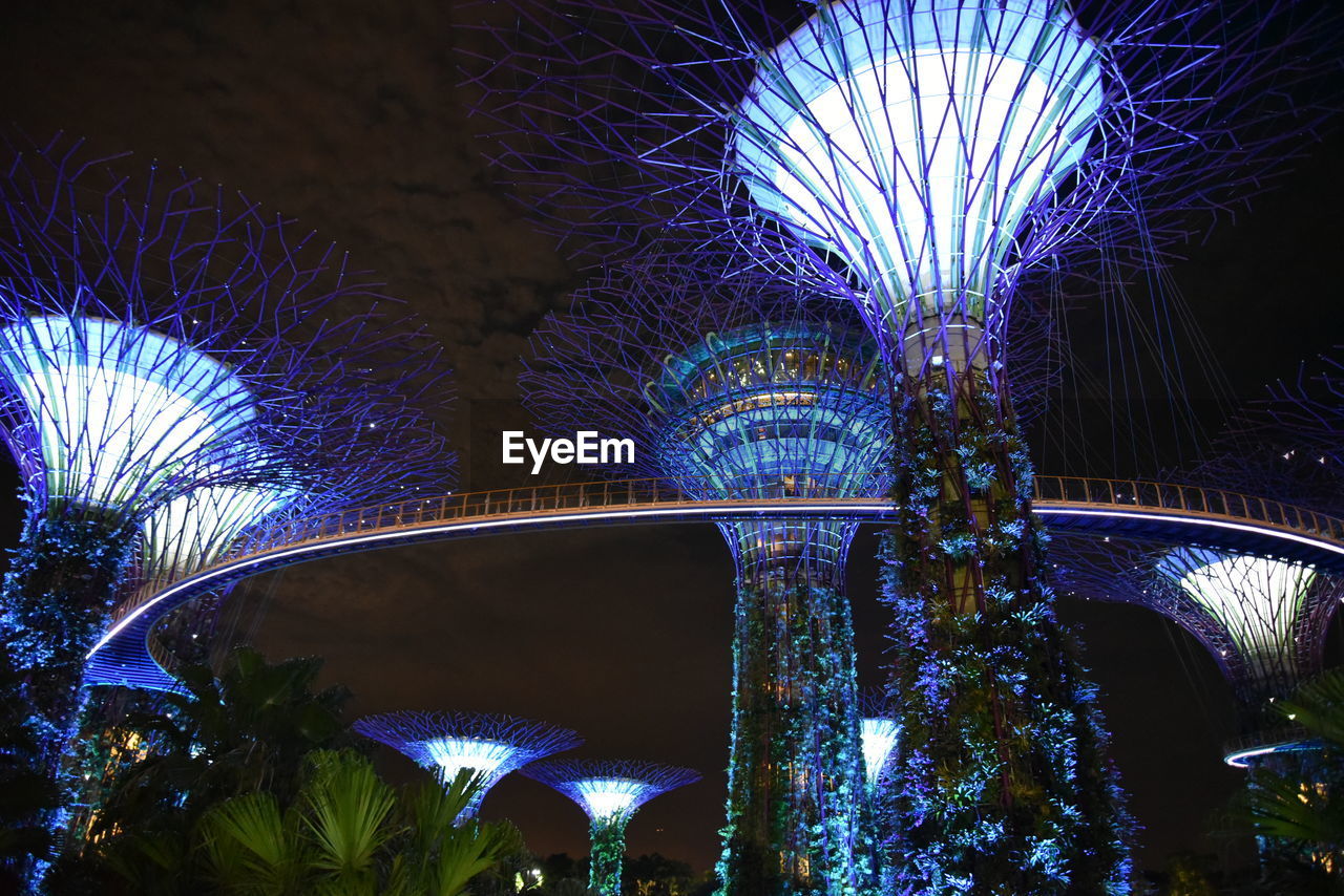 LOW ANGLE VIEW OF ILLUMINATED BRIDGE AGAINST BLUE SKY