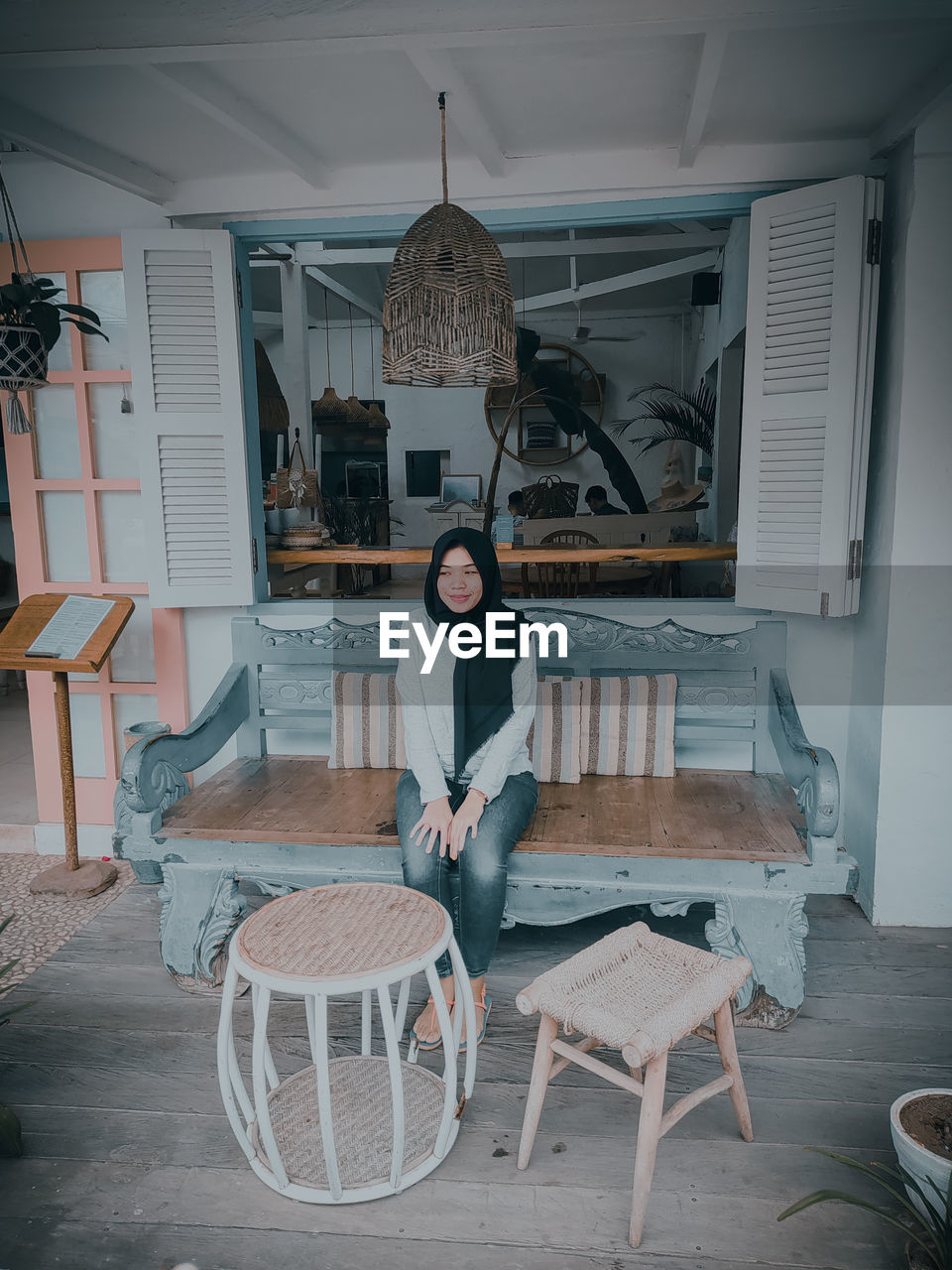 Portrait of woman sitting on table at home