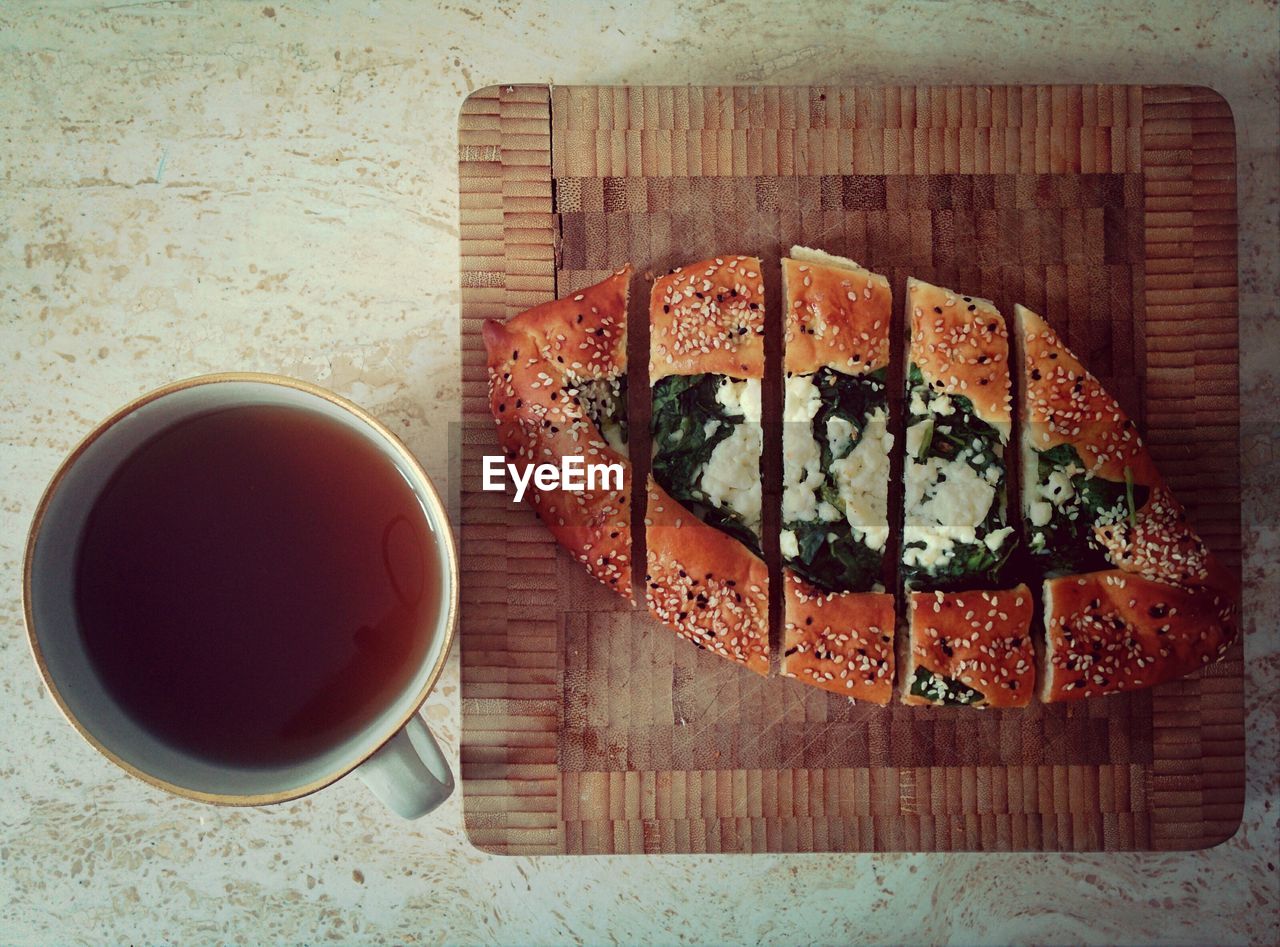 Directly above shot of black tea and pide served on table