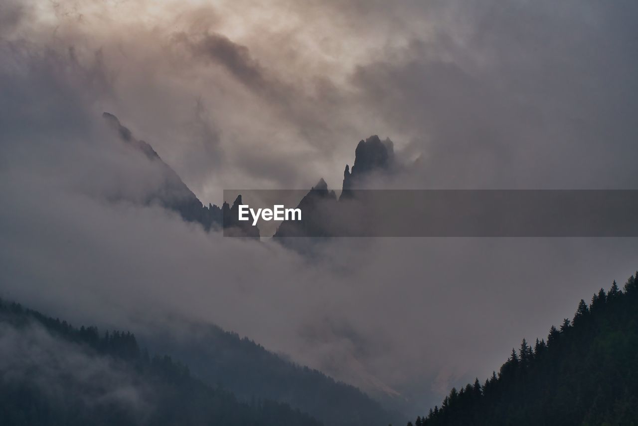 LOW ANGLE VIEW OF CLOUDS OVER MOUNTAIN