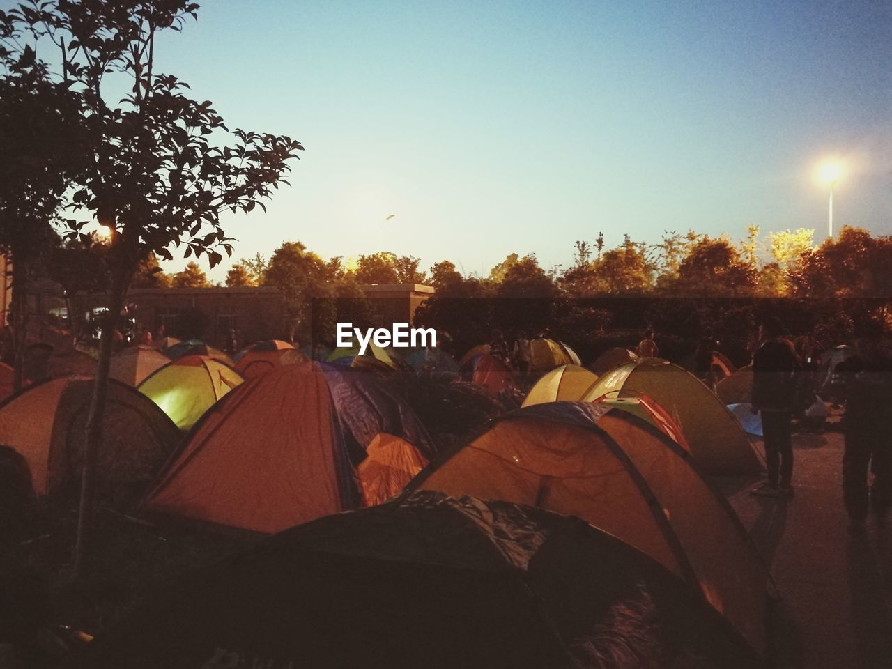 People standing by tents against sky