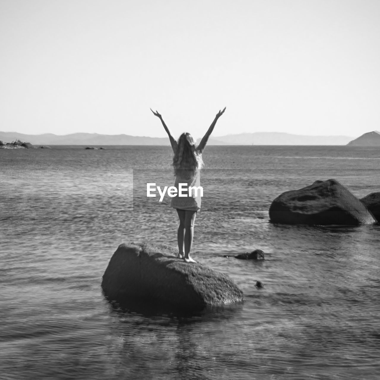 WOMAN STANDING IN WATER