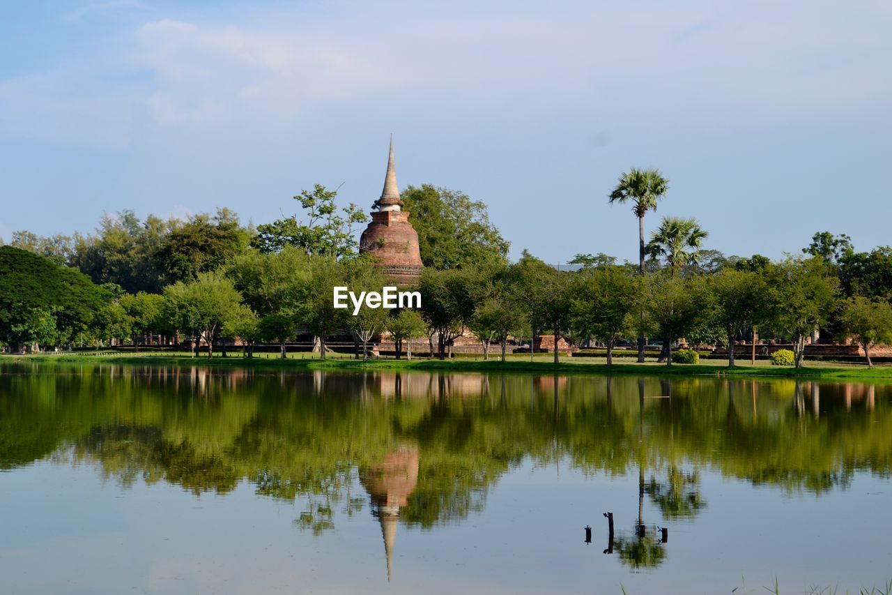 Reflection of stupa on calm lake at sukhothai historical park