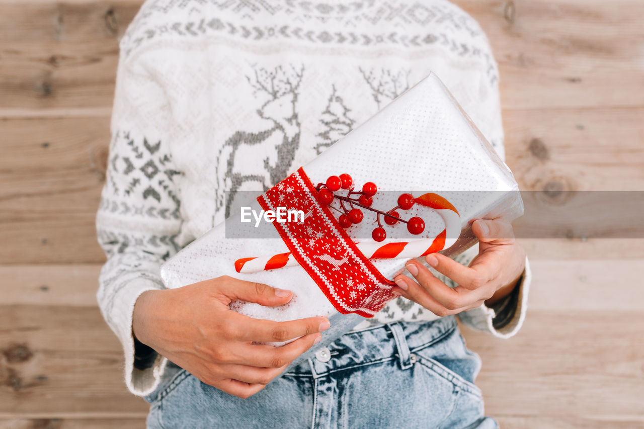 Midsection of woman holding christmas gift