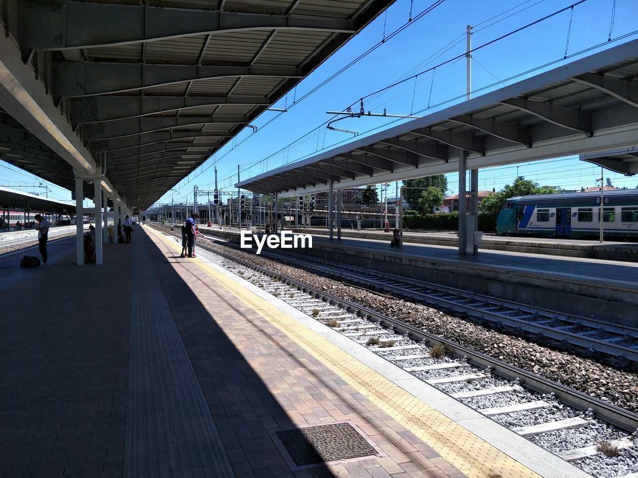 TRAIN AT RAILROAD STATION PLATFORM AGAINST CLEAR SKY