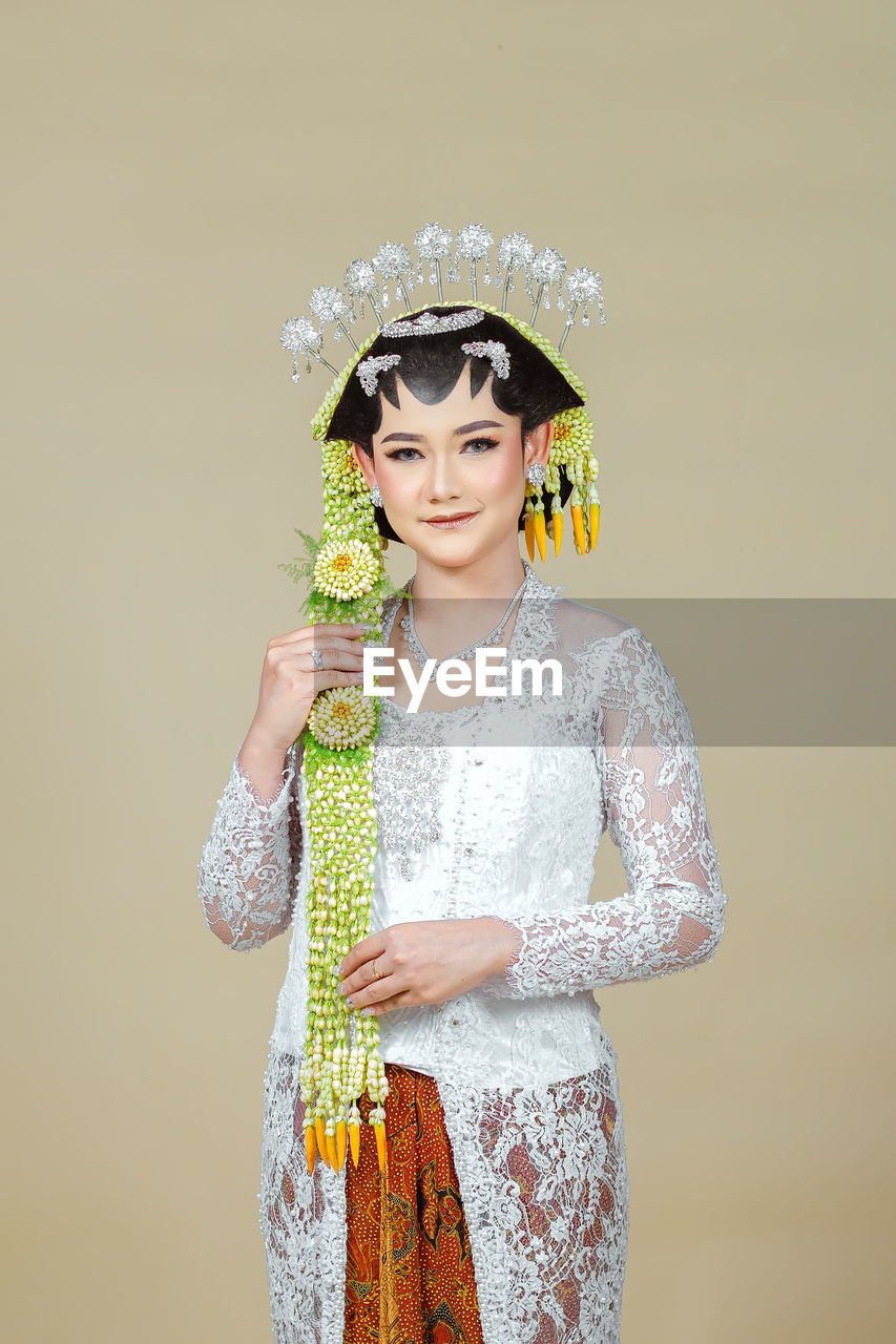 Beautiful model, wearing javanese indonesian wedding dress.