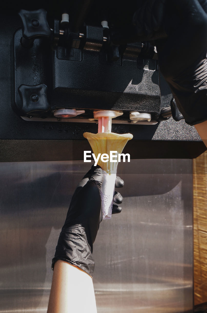 Employees are making ice cream from an ice cream machine.