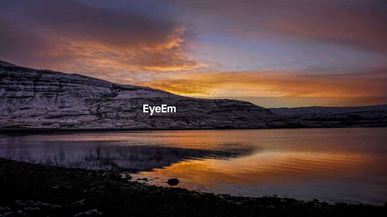 Scenic view of lake against sky during sunset