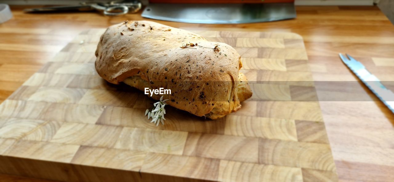 food and drink, food, indoors, freshness, cutting board, table, bread, wood, baked, no people, wellbeing, healthy eating, still life, produce, fast food, close-up, high angle view, domestic room, focus on foreground