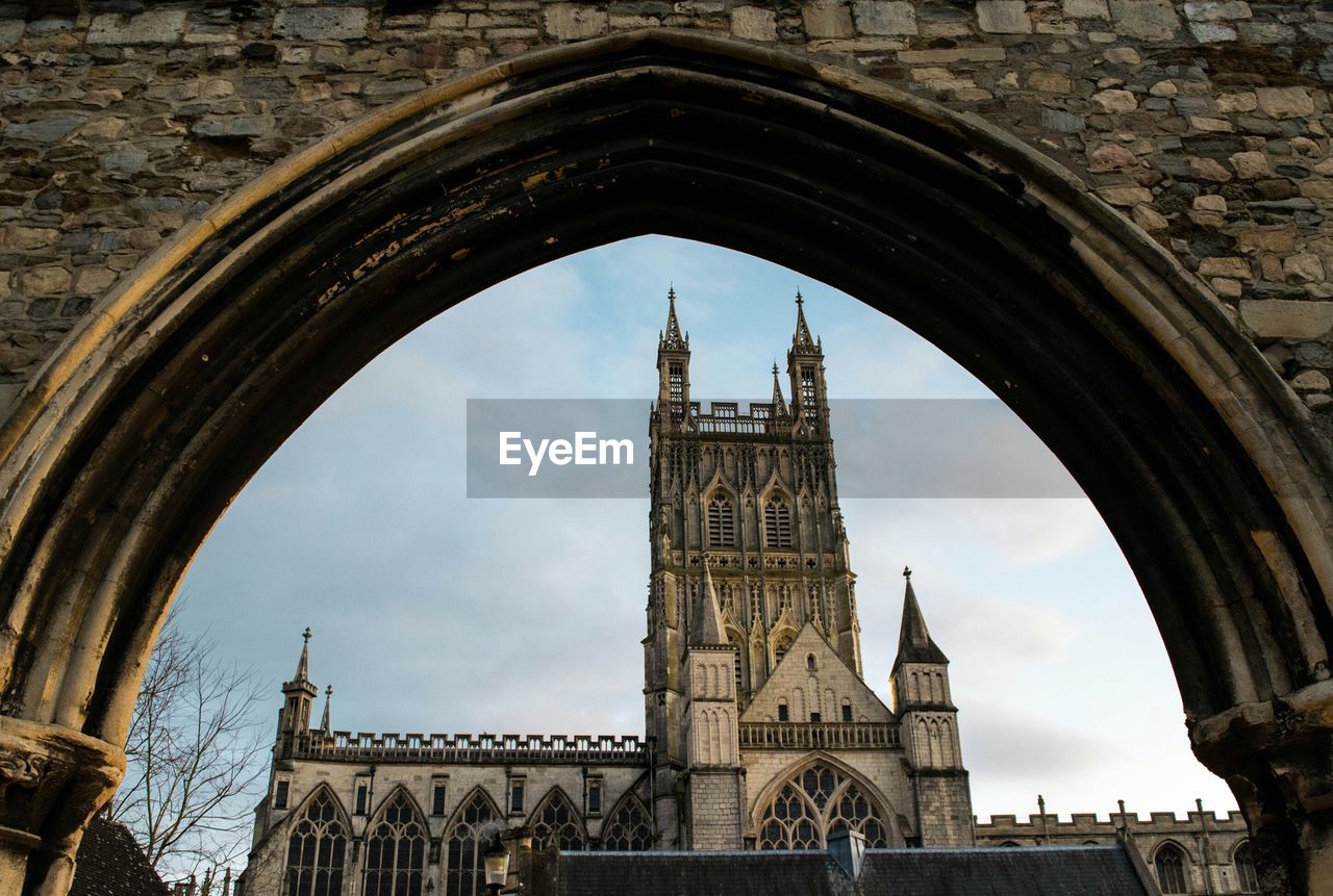 Gloucester cathedral seen through infirmary arches