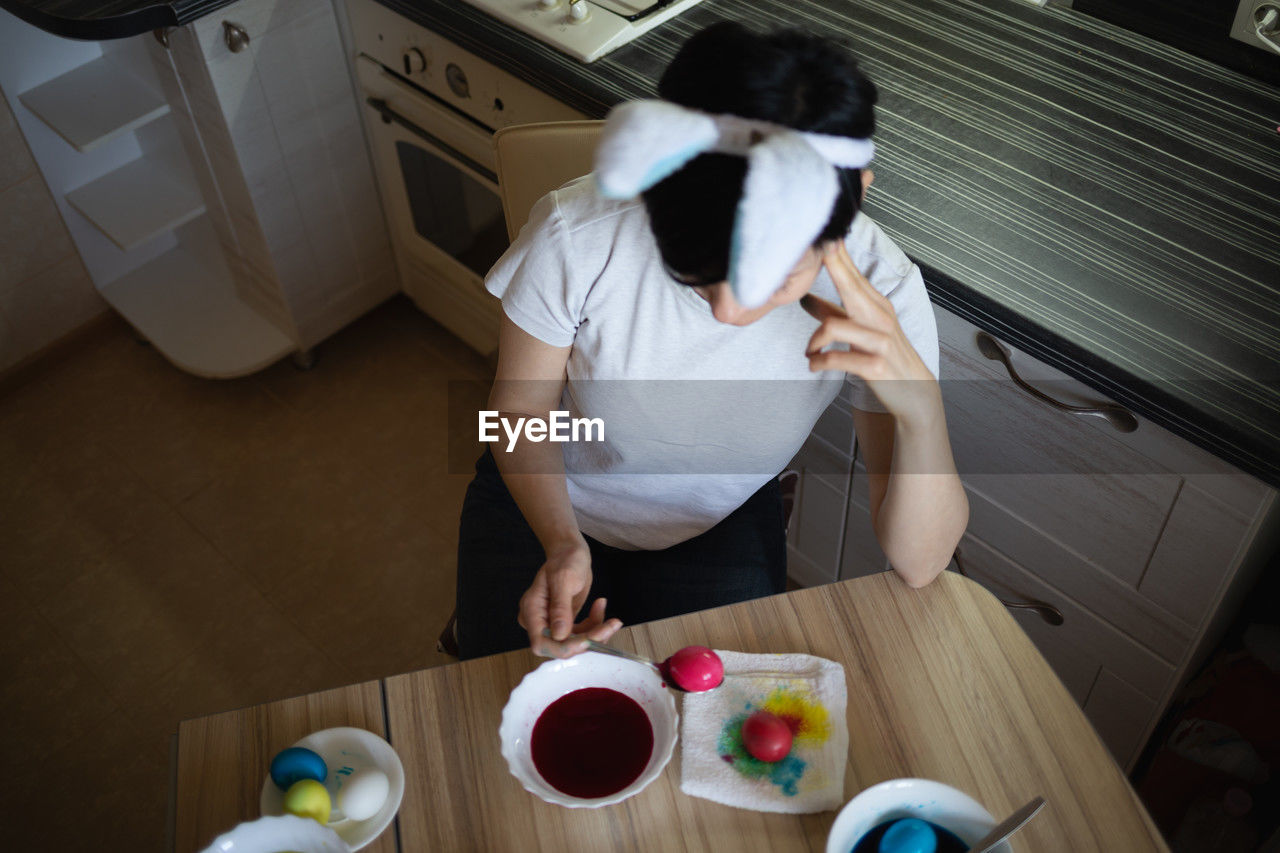 high angle view of boy with dog on floor at home