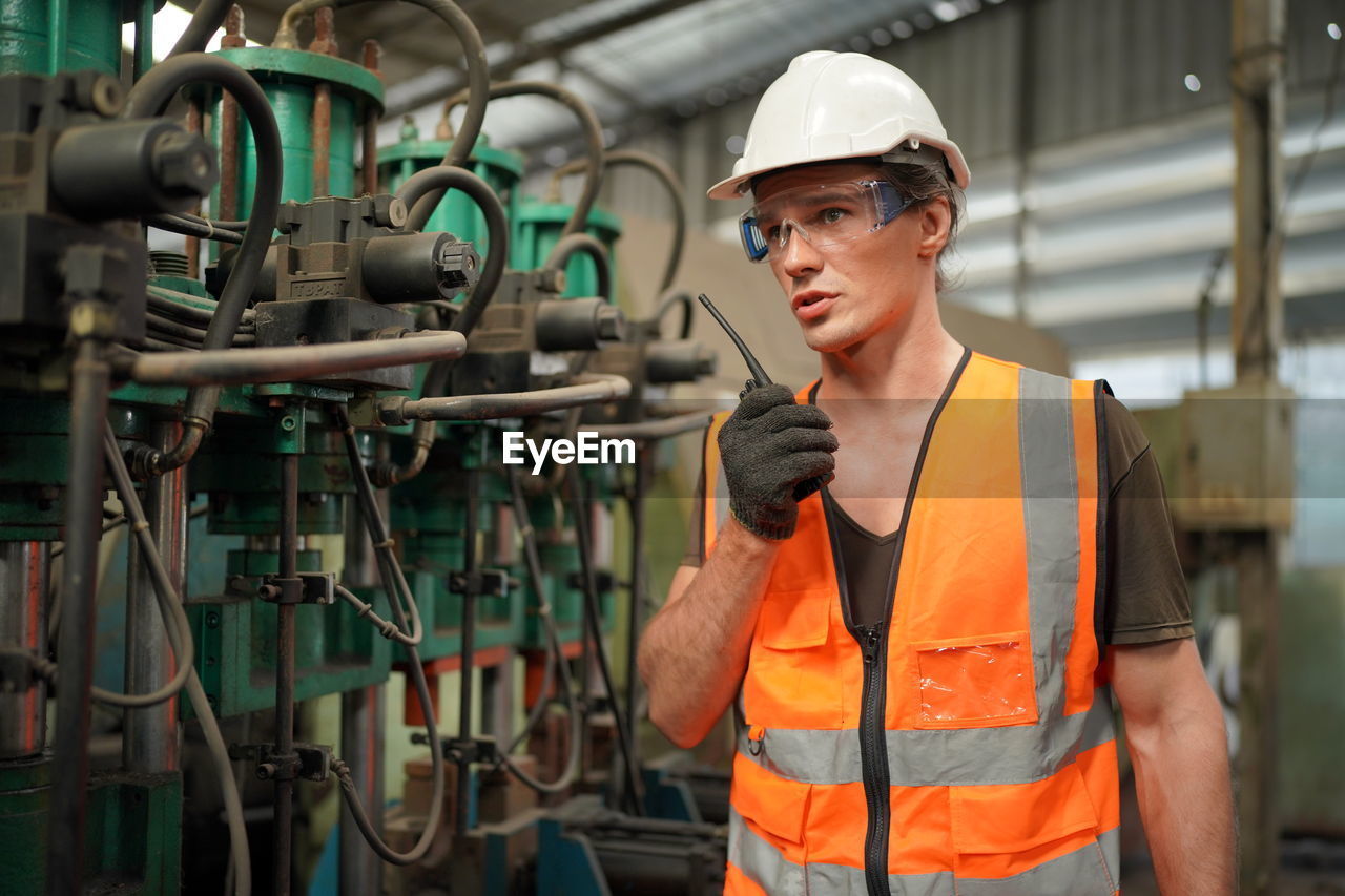 portrait of young man working in factory
