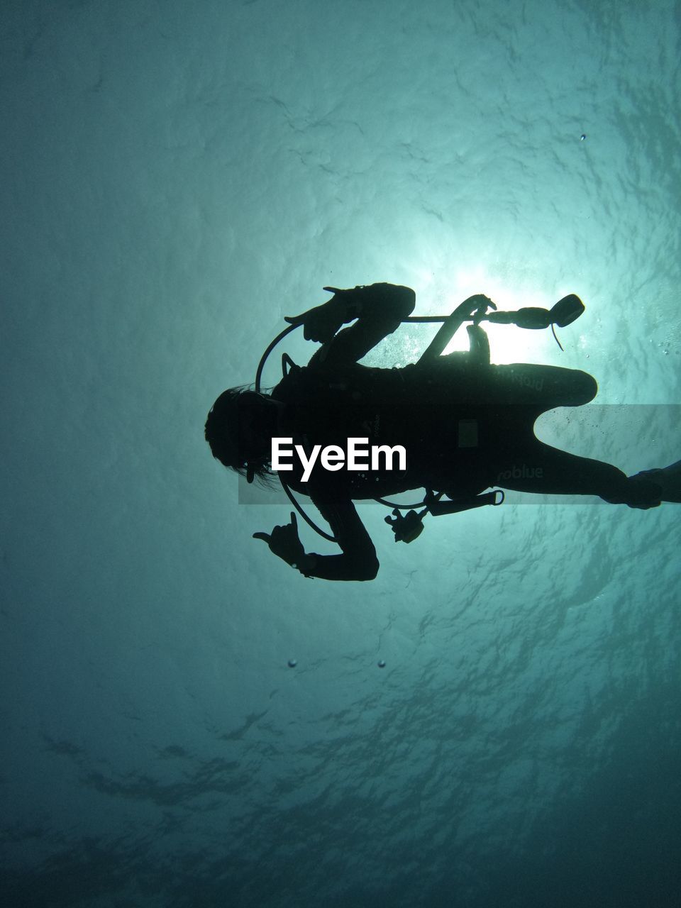 Woman scuba diving in sea.