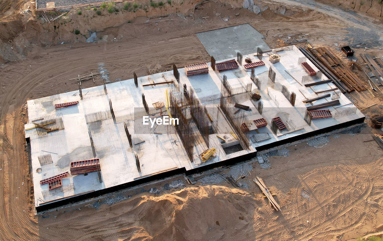 HIGH ANGLE VIEW OF STACK OF WOOD AT SHORE