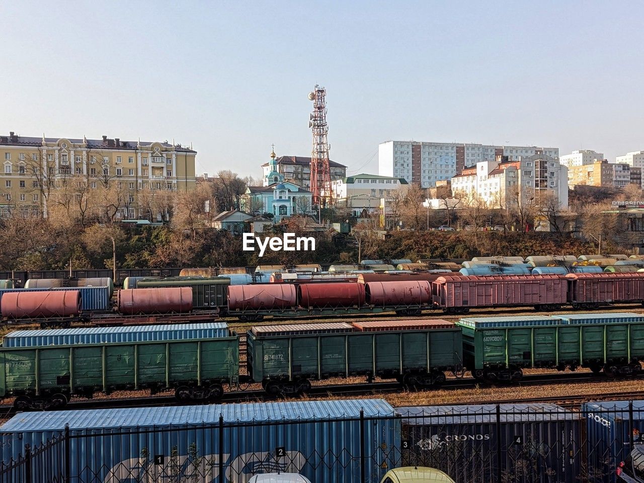 Freight trains and buildings against the clear sky