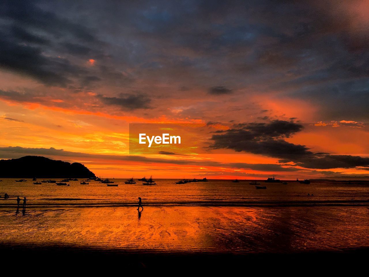 Scenic view of sea against orange sky