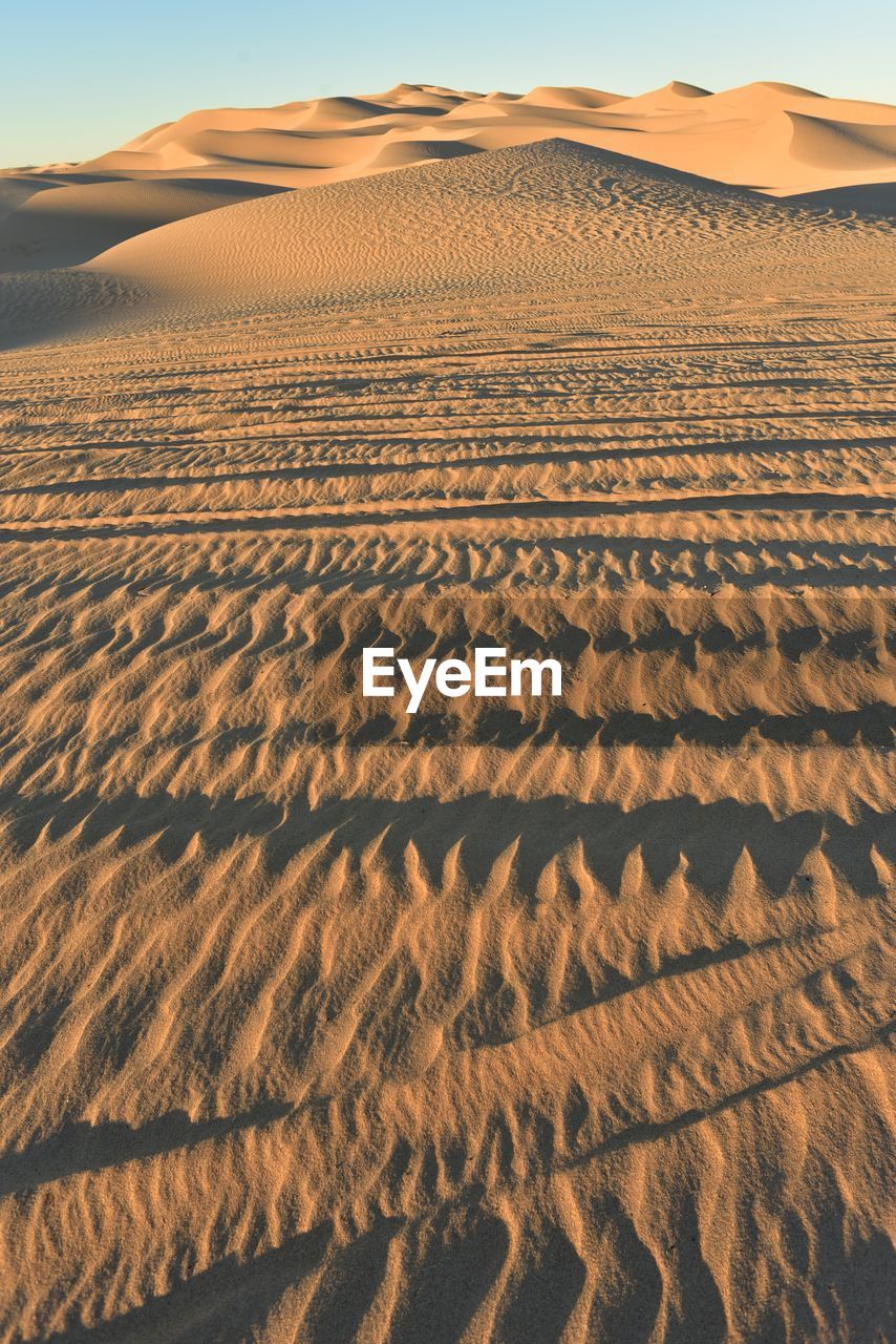 Scenic view of desert against sky during sunset