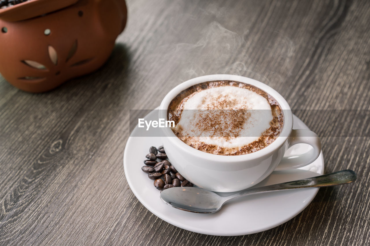 HIGH ANGLE VIEW OF COFFEE CUP ON TABLE AT HOME