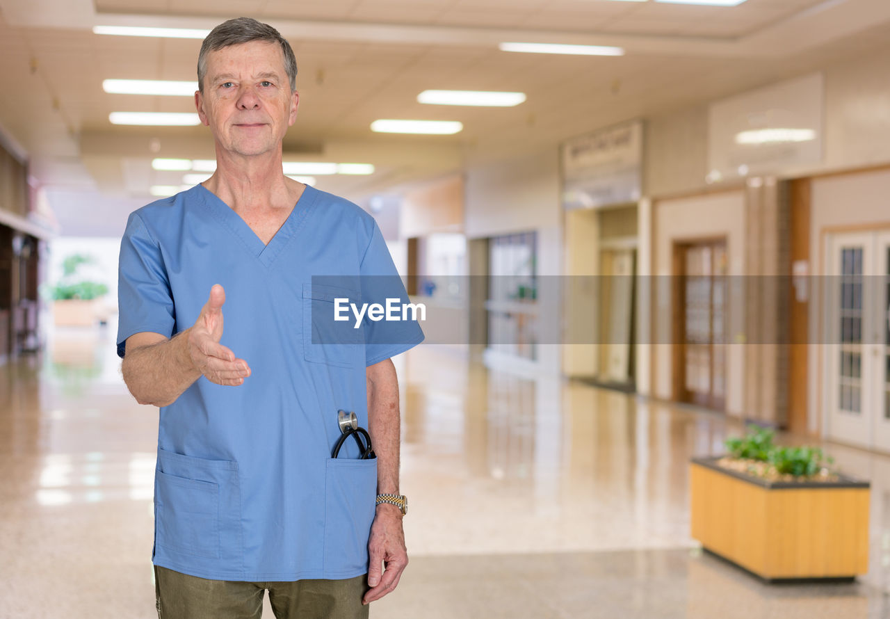 Portrait of doctor standing in corridor