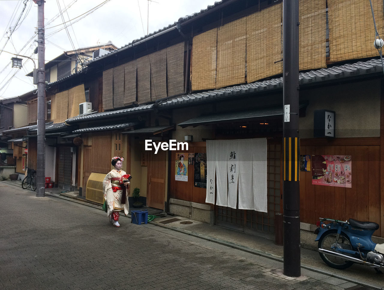 MAN STANDING ON OLD BUILDING