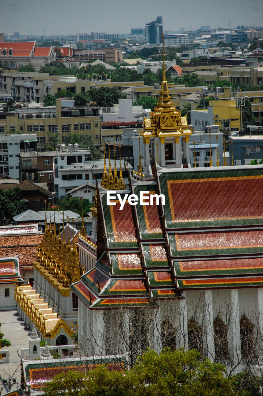 HIGH ANGLE VIEW OF BUILDINGS AGAINST BLUE SKY