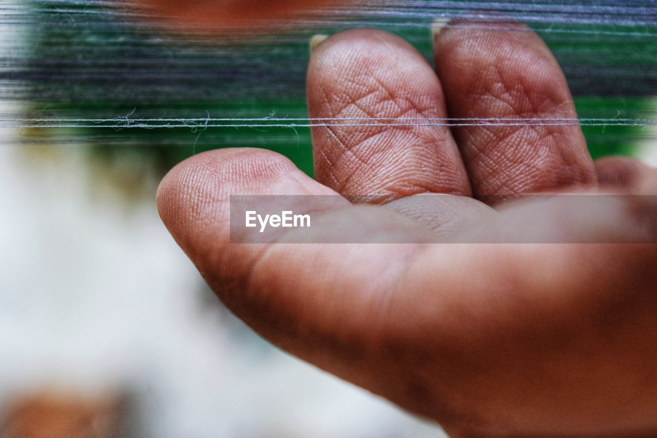 Close-up of fingers touching strings