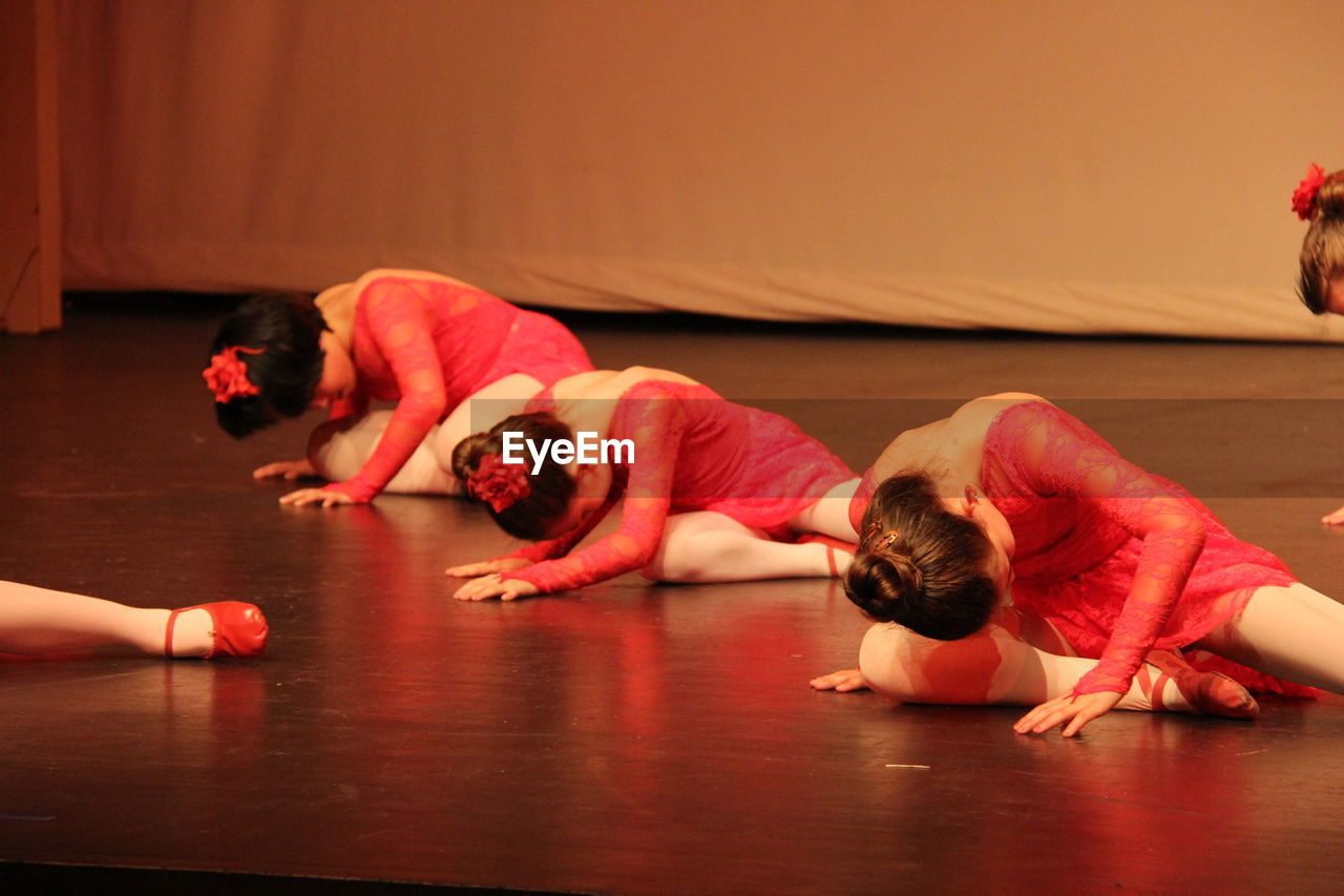 WOMAN LYING DOWN IN RED DRESS