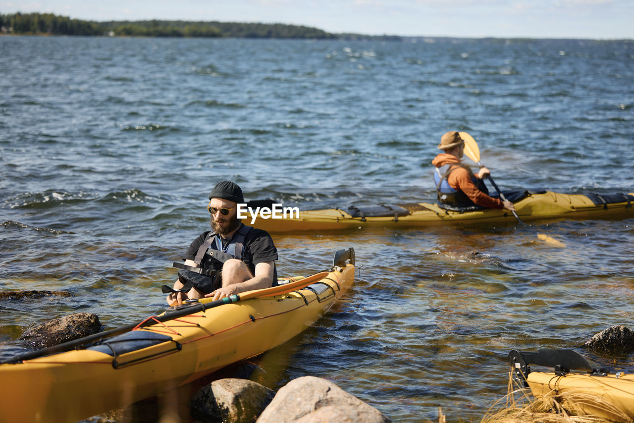 View of two men in kayaks at sea