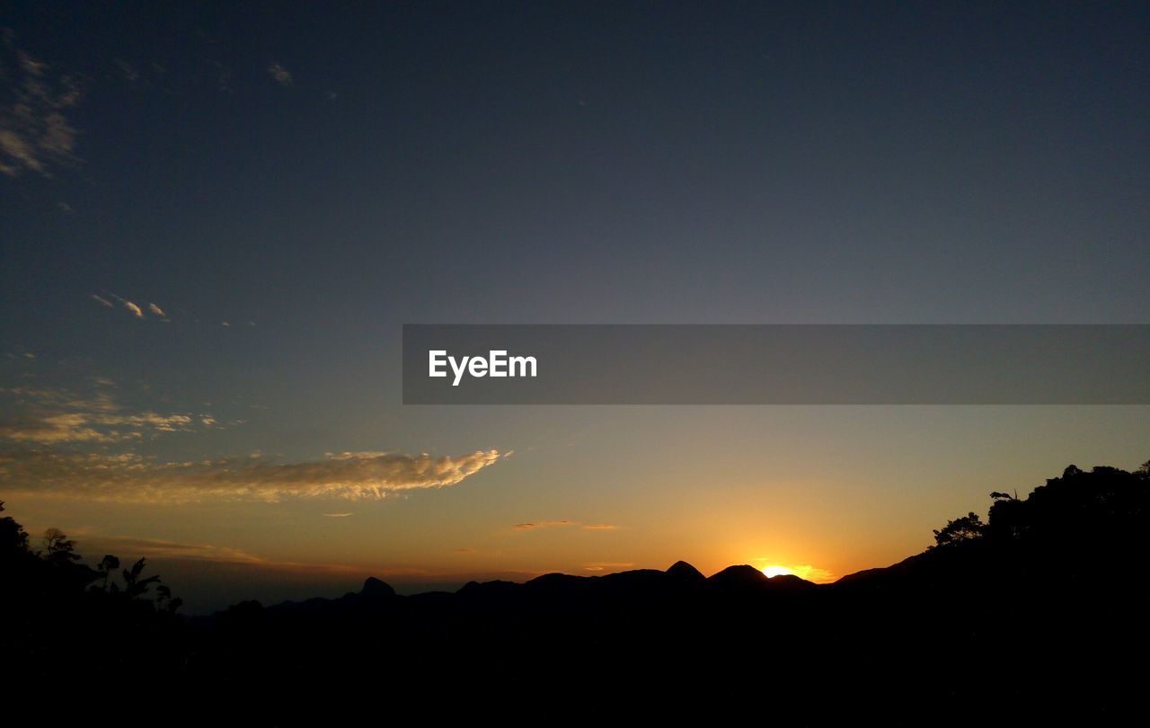 Silhouette of landscape against sky during sunset