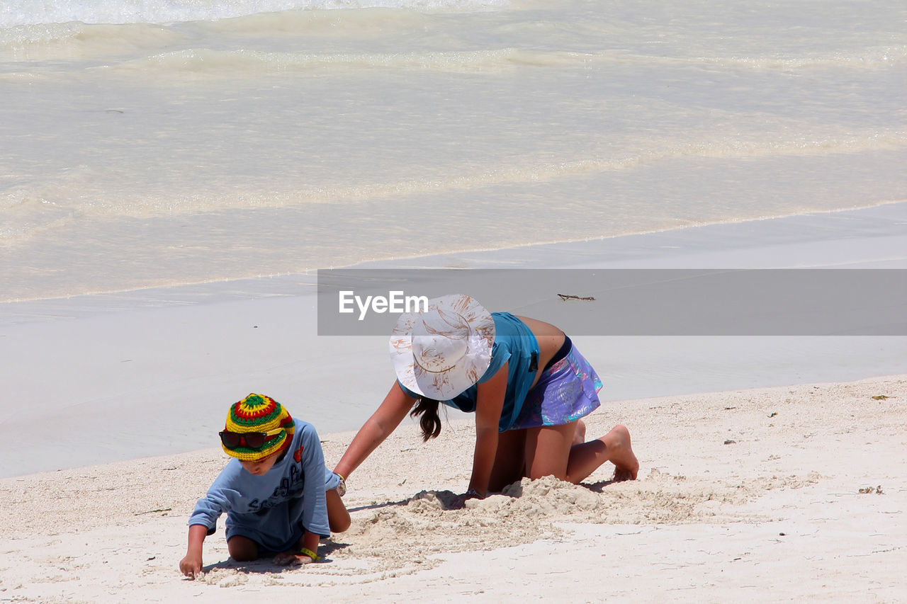 Children playing on sand at beach