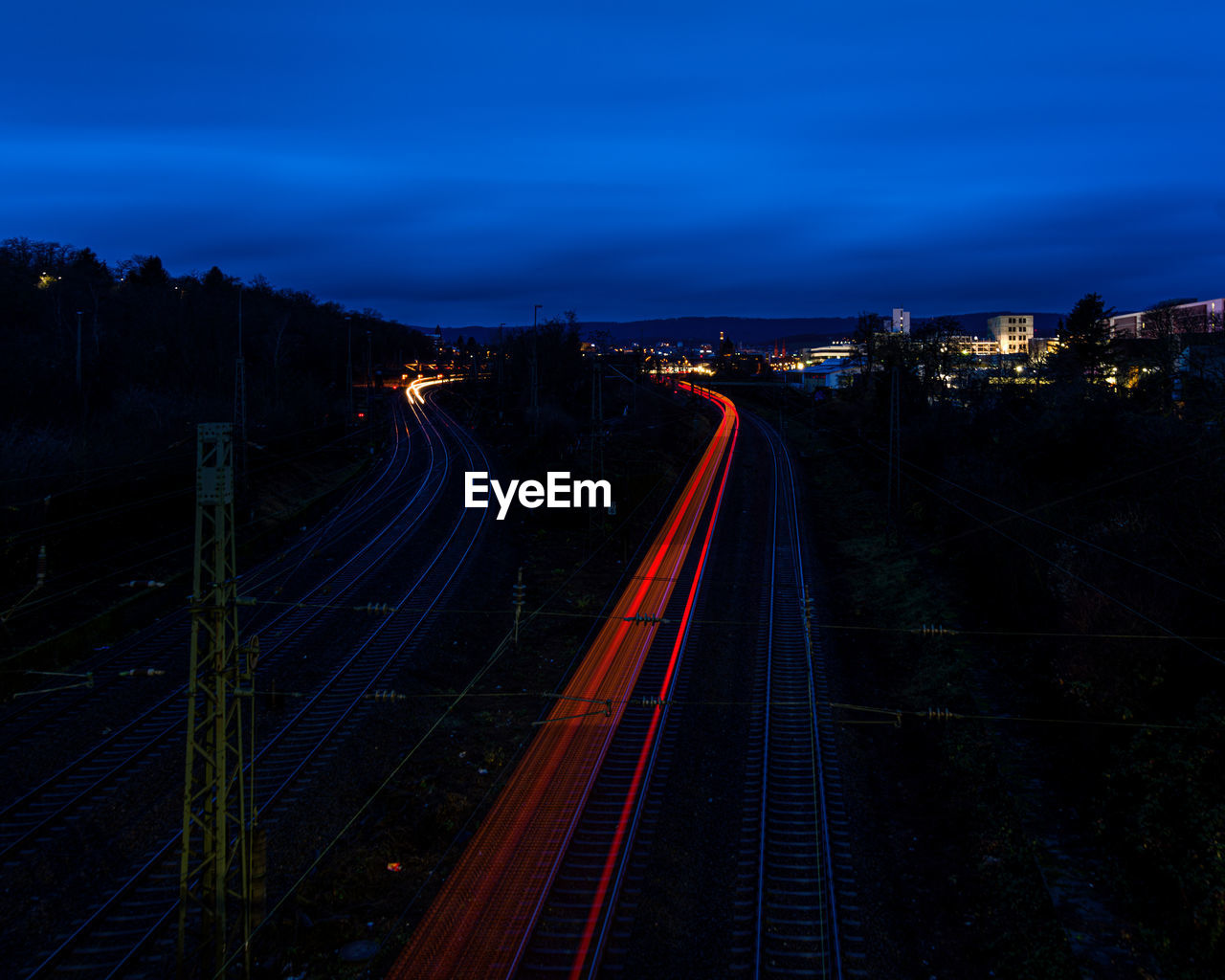 High angle view of light trails on railroad tracks at night
