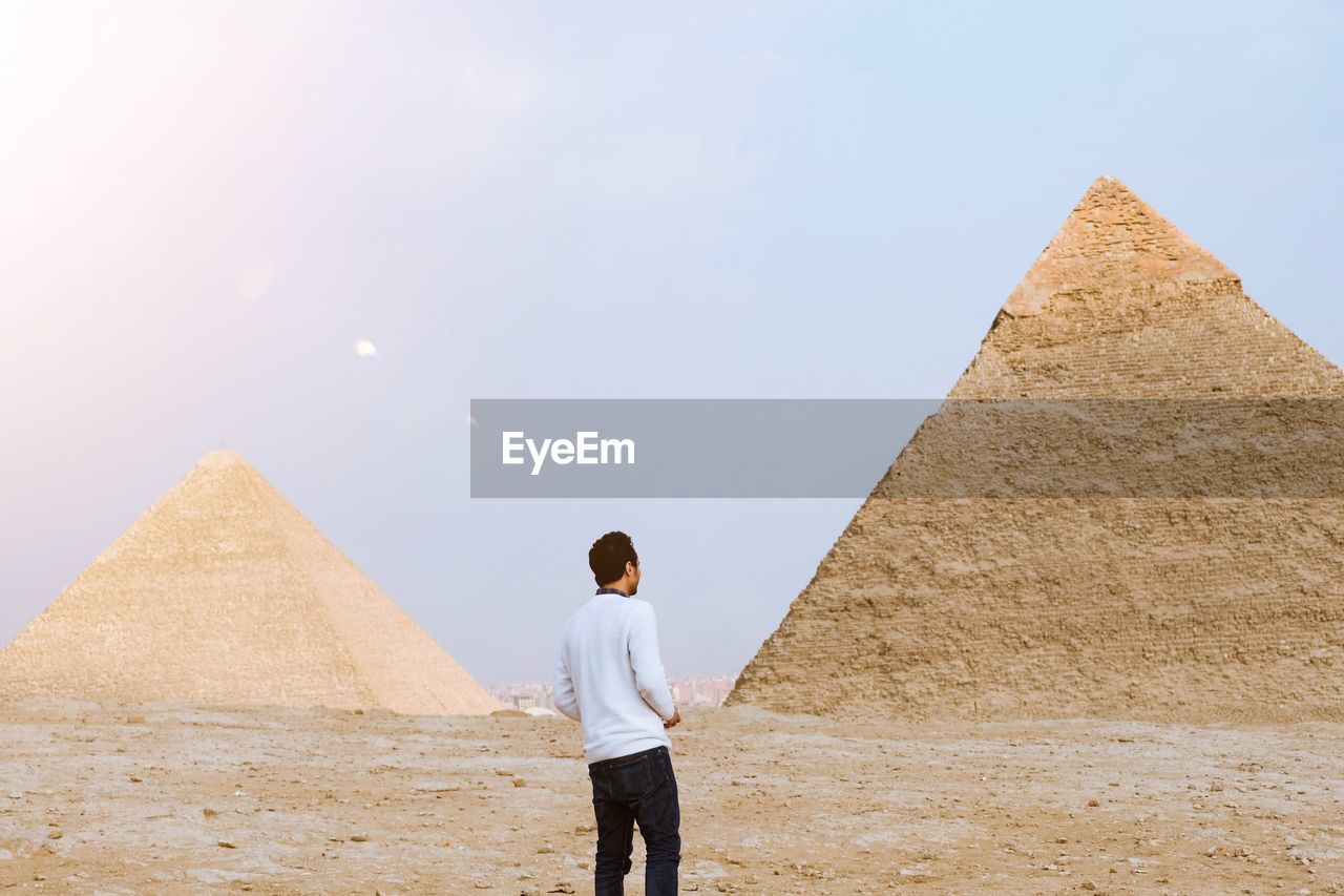 Man looking at pyramids