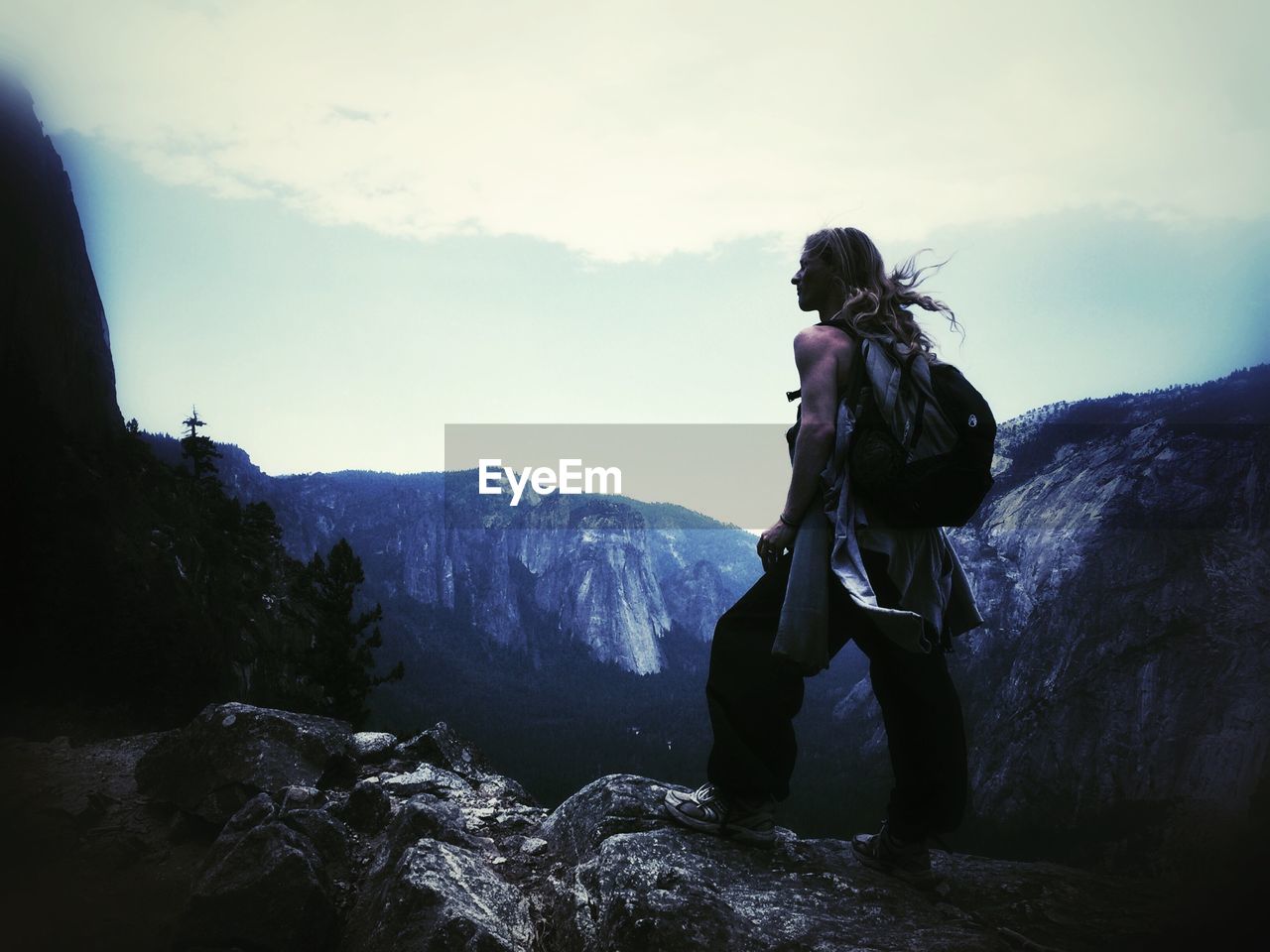 WOMAN STANDING ON MOUNTAIN