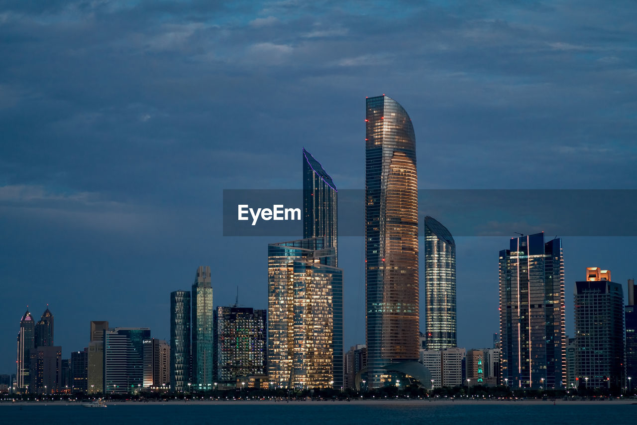 View of skyscrapers against cloudy sky