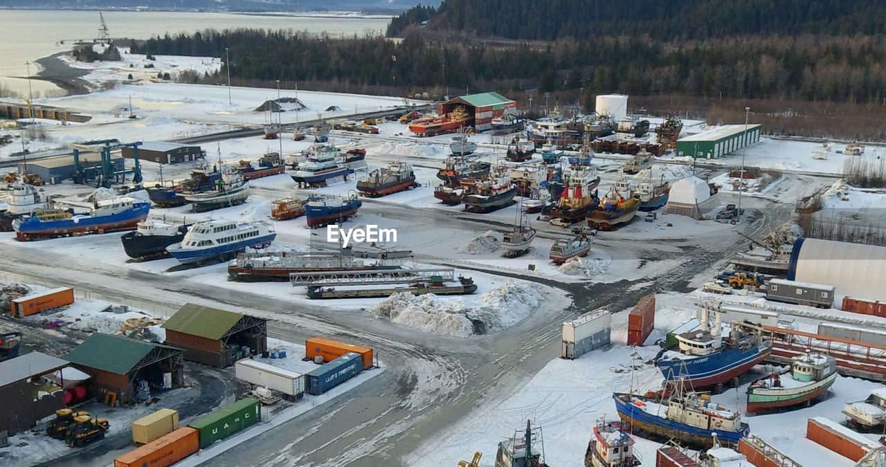 HIGH ANGLE VIEW OF BOATS MOORED AT HARBOR