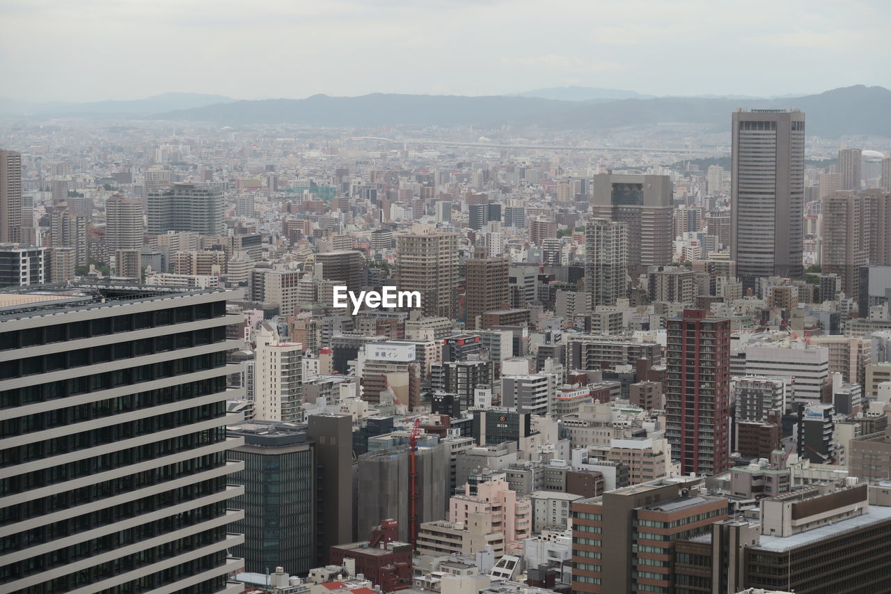 High angle view of modern buildings in city against sky