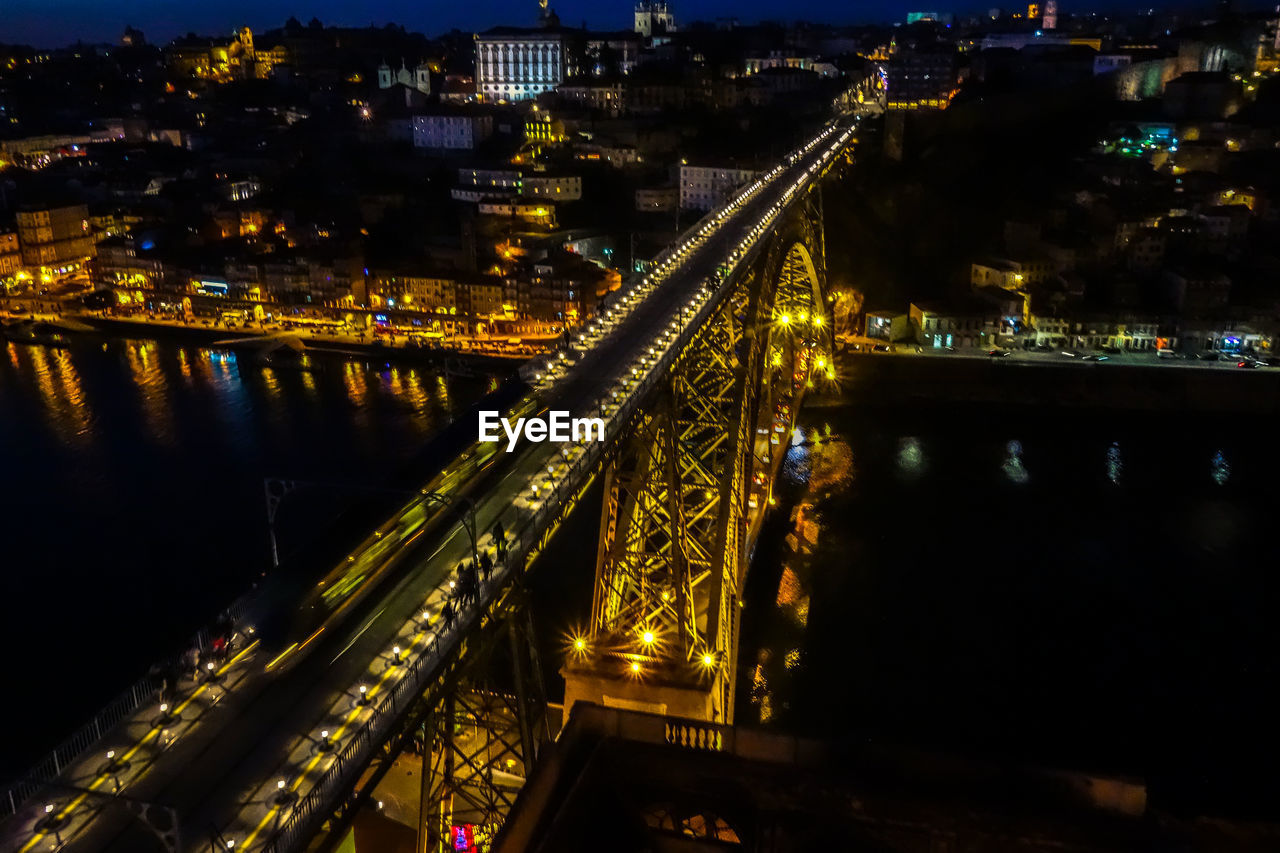 HIGH ANGLE VIEW OF BRIDGE OVER RIVER AT NIGHT