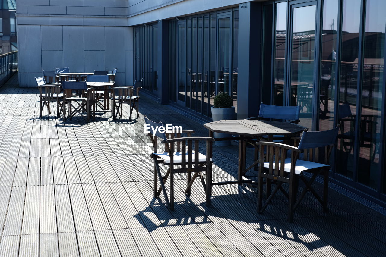 Empty chairs and tables outside restaurant