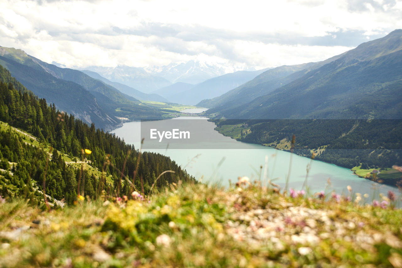 Scenic view of lake and mountains against sky