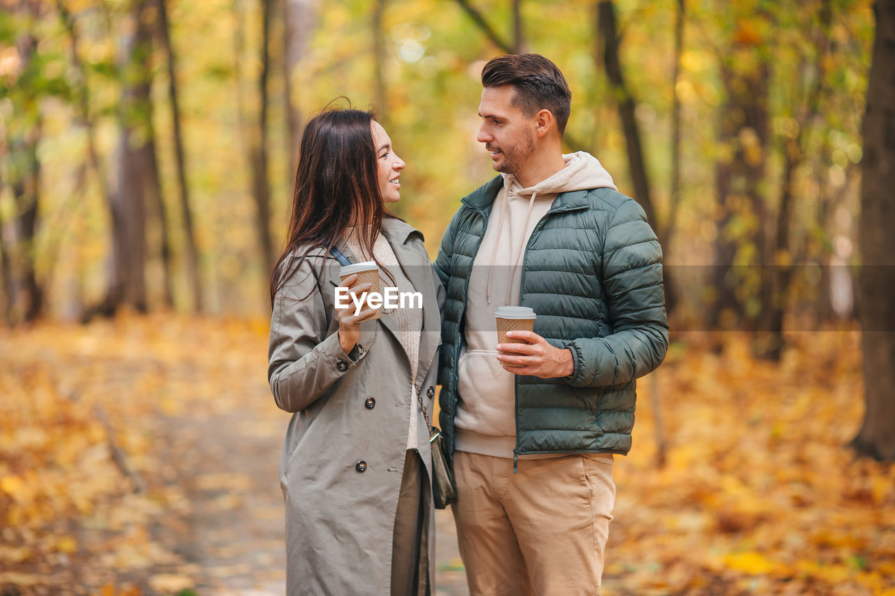 Couple standing in forest during autumn