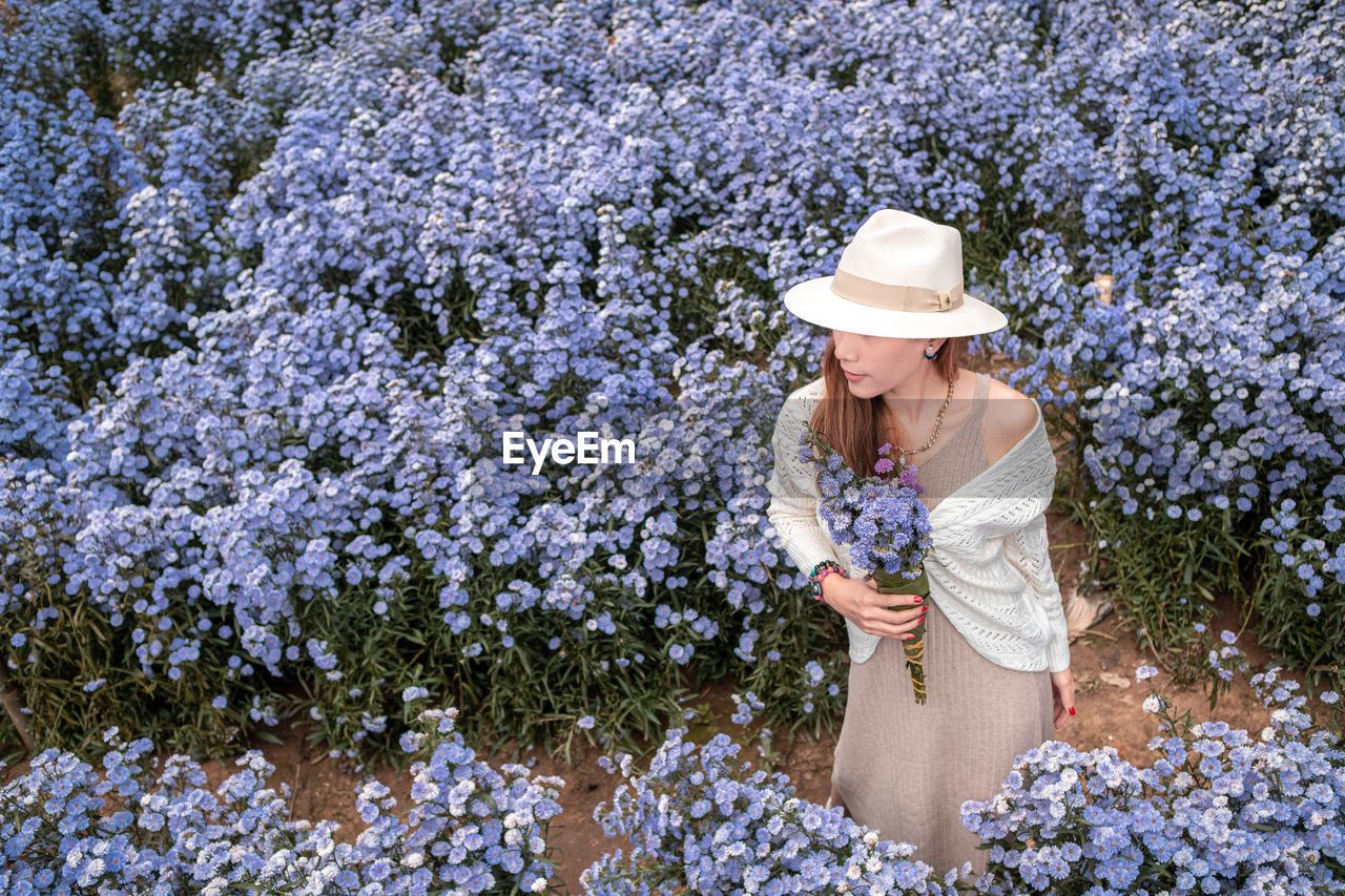 Full length of woman with  flowers