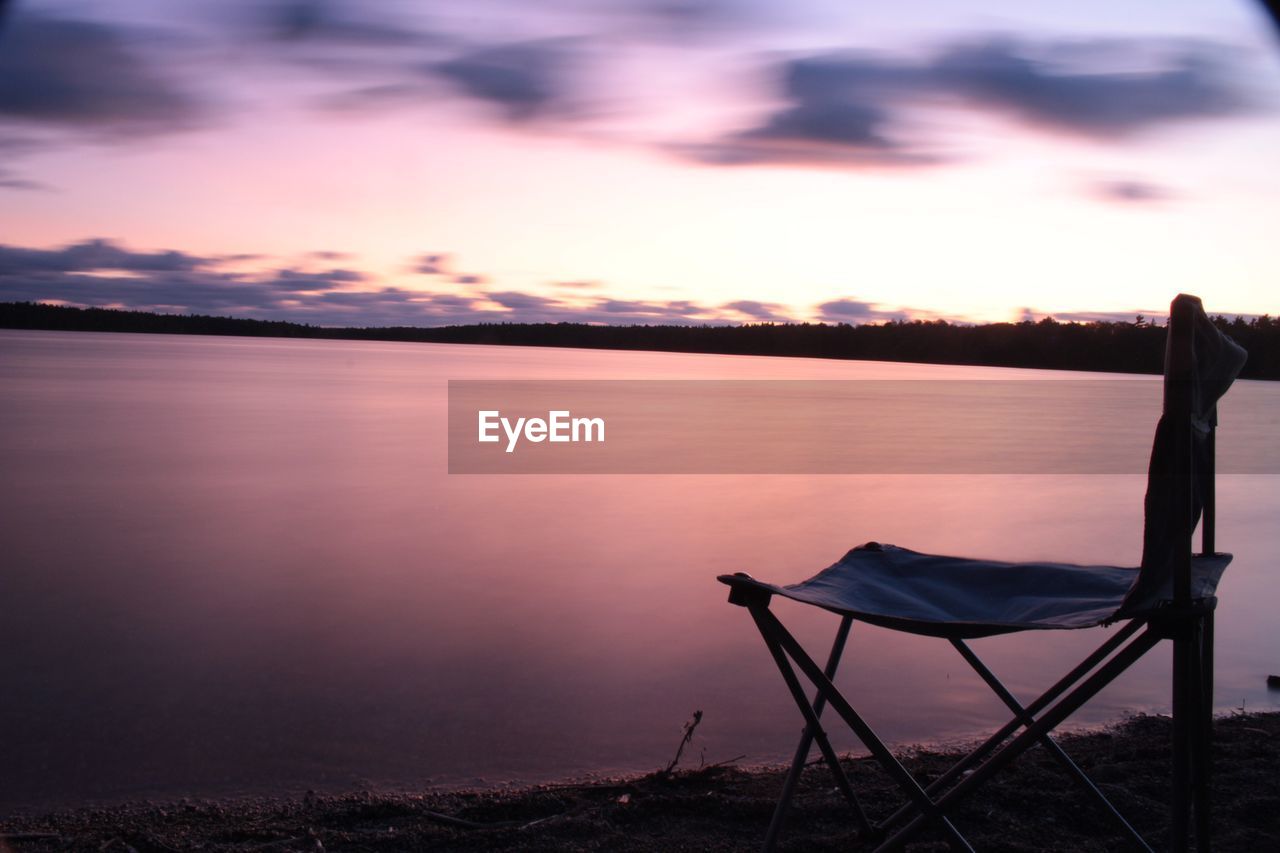 SCENIC VIEW OF LAKE AT SUNSET