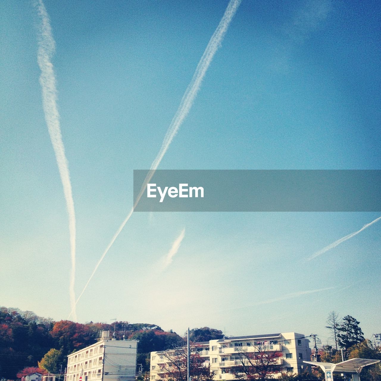 LOW ANGLE VIEW OF BUILDINGS AGAINST BLUE SKY AND CLOUDS