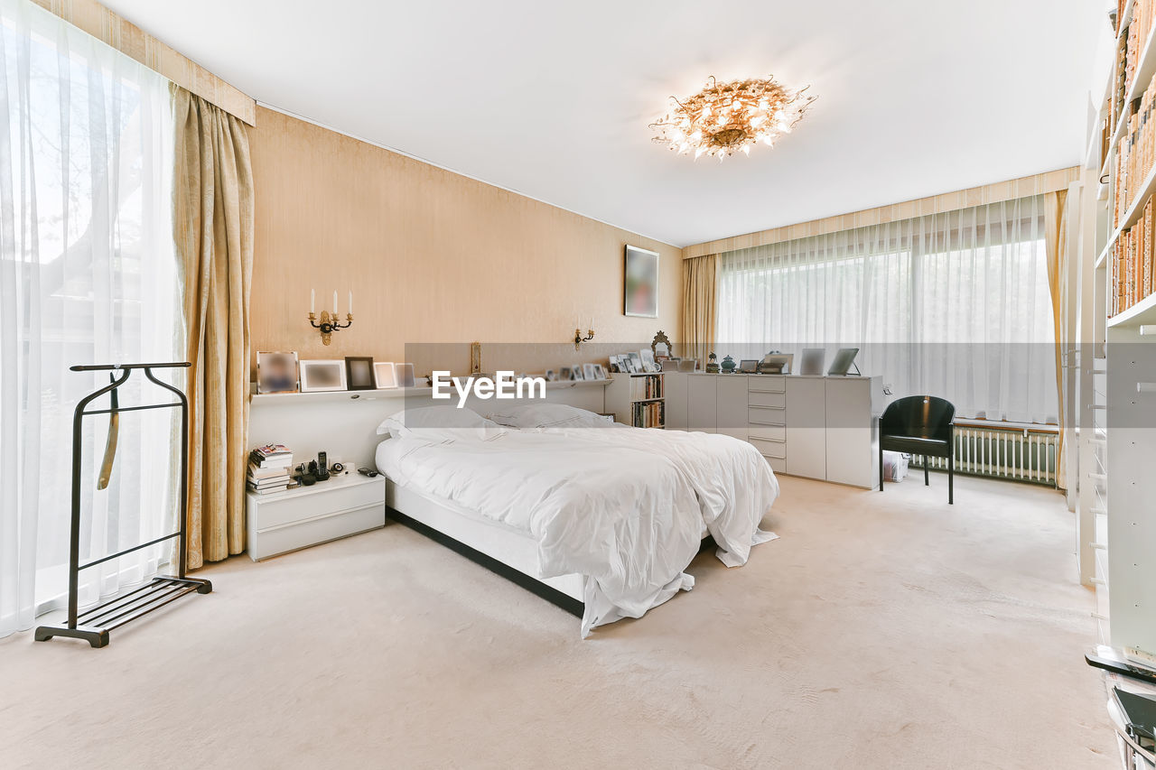 INTERIOR OF EMPTY BED IN ROOM