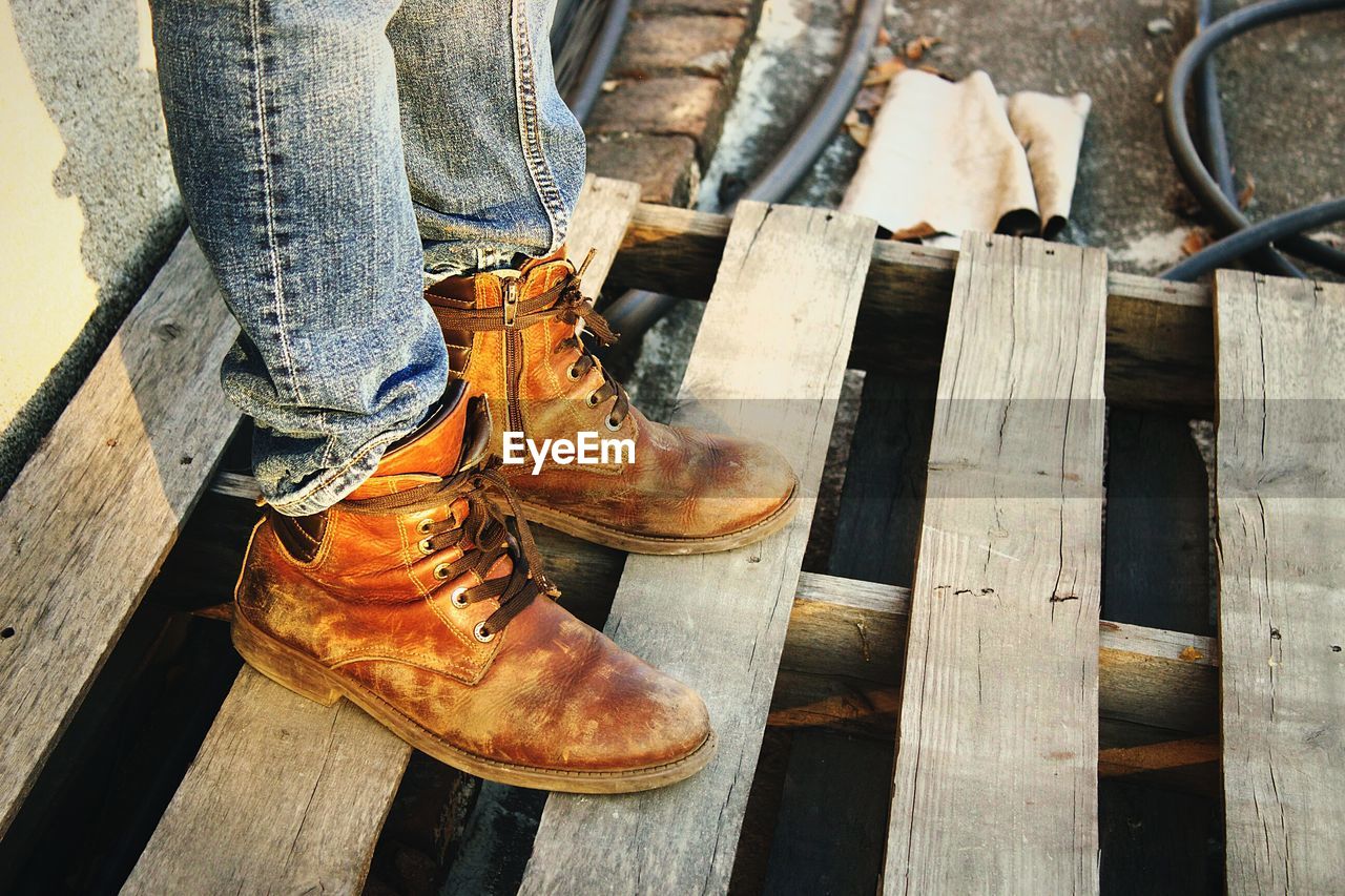 Low section of woman standing on wood