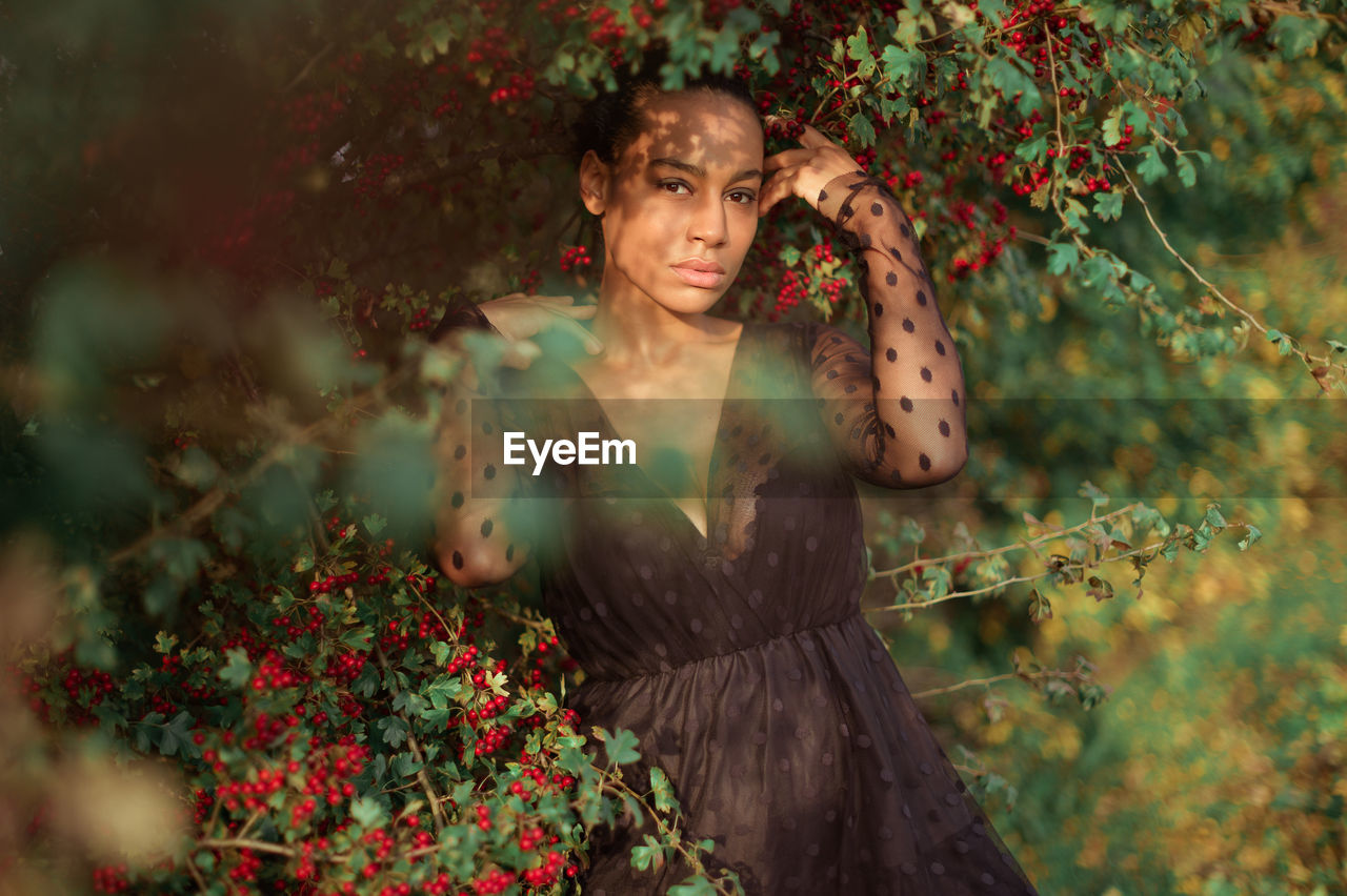 Portrait of woman against plants