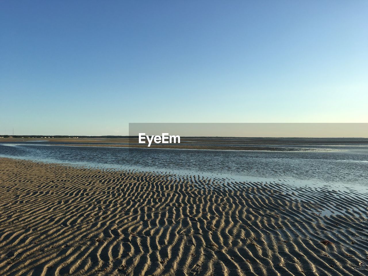 Scenic view of beach against clear sky