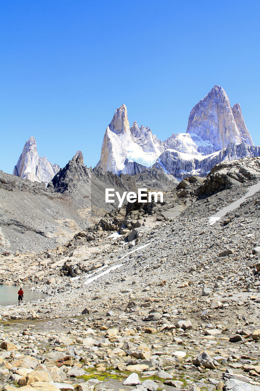 Scenic view of snowcapped mountains against clear blue sky at fitz roy range