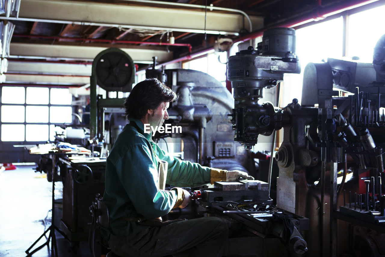 Man using machinery in workshop