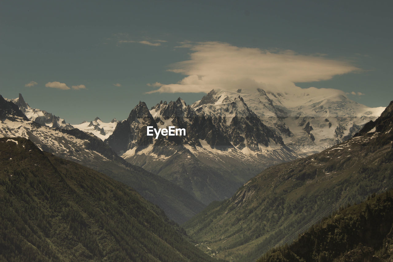 Scenic view of snowcapped mountains against sky during sunset